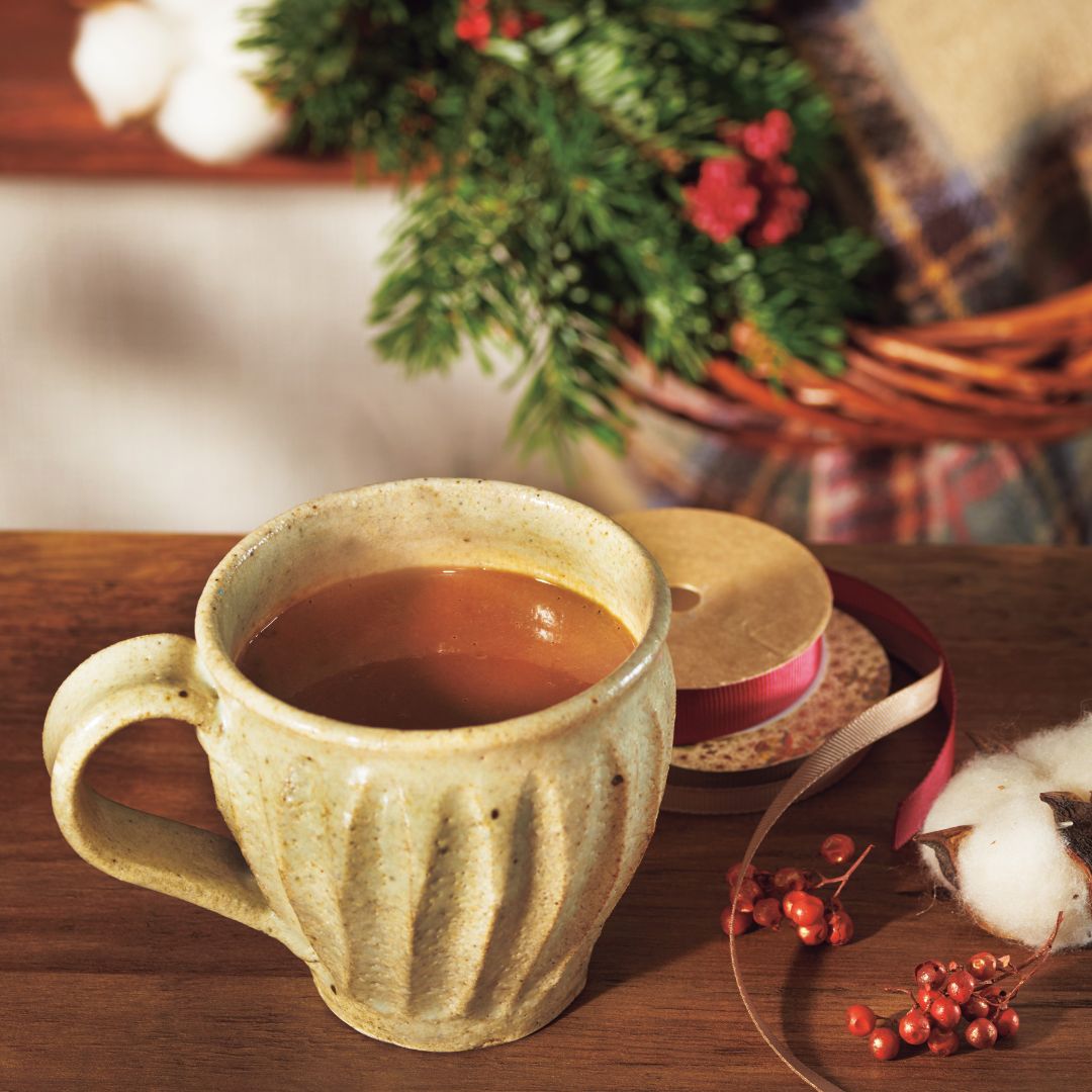 ROYCE' Chocolate - Chocolate Mix for Drink - Image shows a cup filled with hot chocolate with accents of a ribbon, some berries, and other holiday decor.